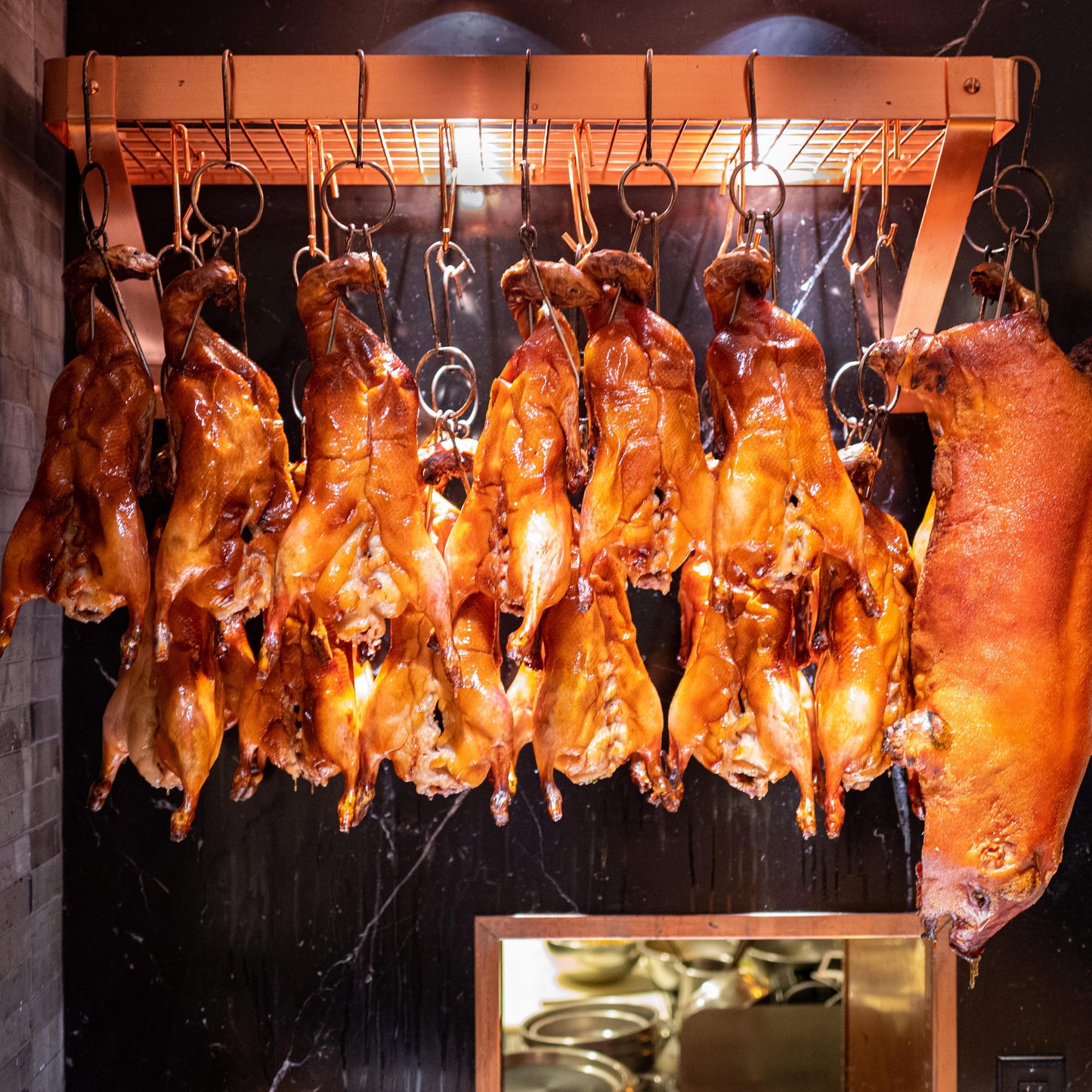 Roasted ducks hanging on a rack 